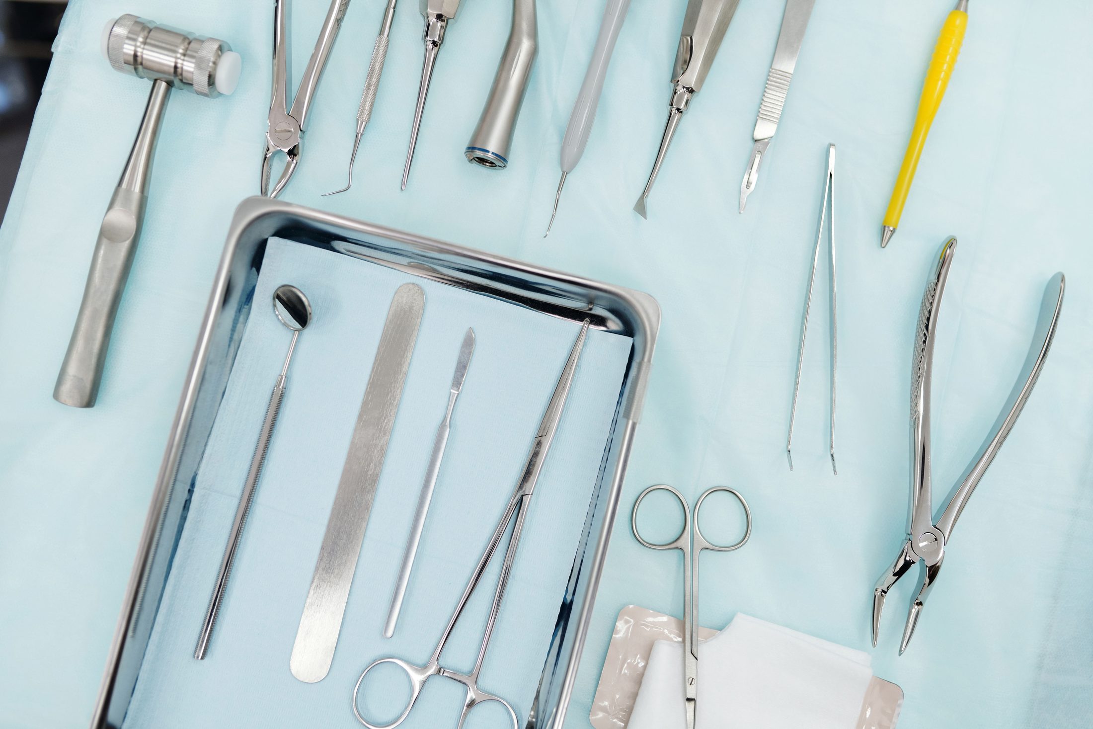 Stainless steel dental instruments laid out on a sterile tray